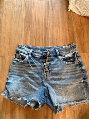 High-Rise Distressed Denim Shorts in Light Blue